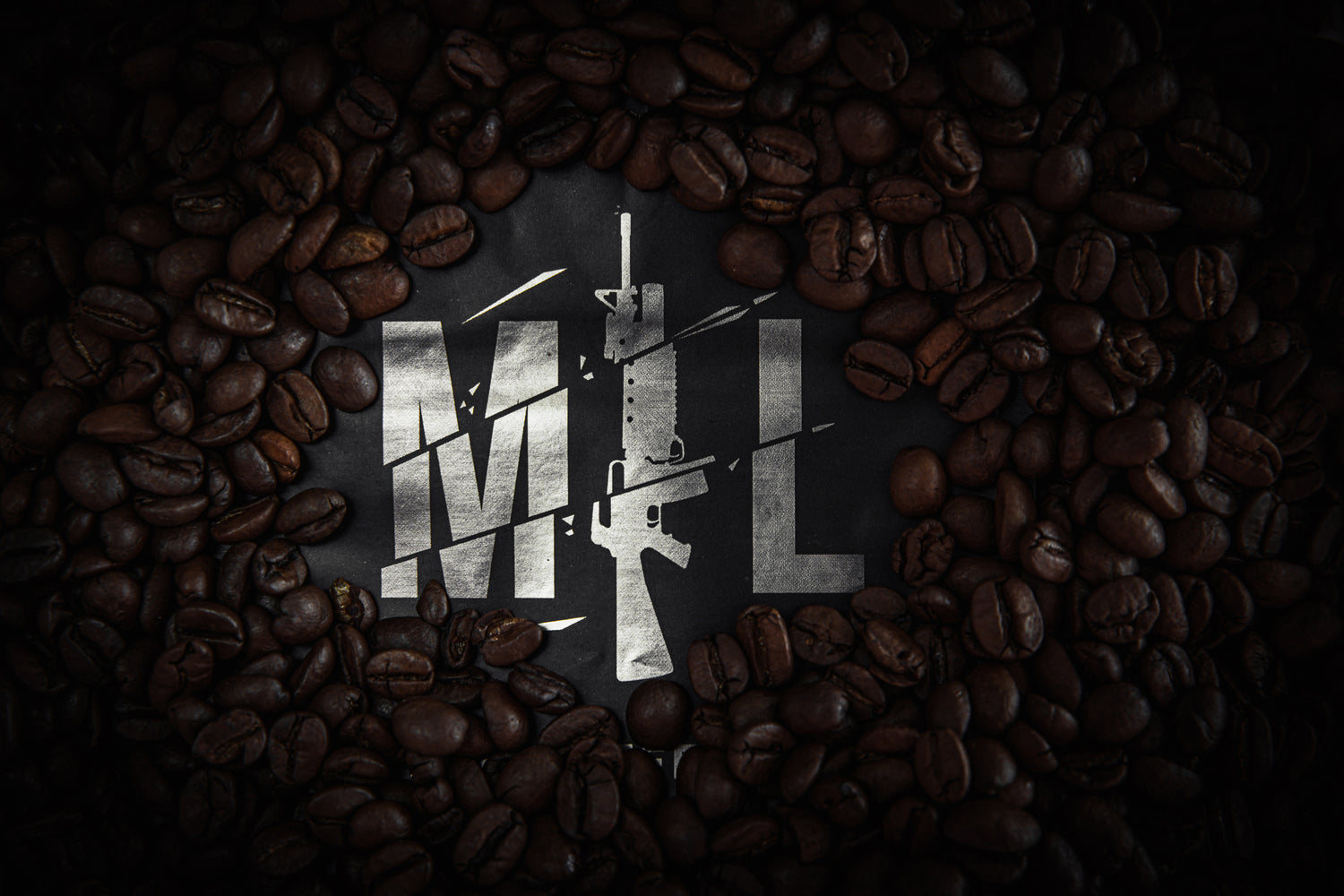 Black sealed Mil-Coffee beans package with Mil-Coffee beans underneath it.